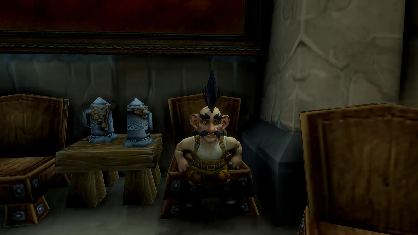 Stubz Flux sitting in a big wooden tavern chair beside two tankards, hands on his knees